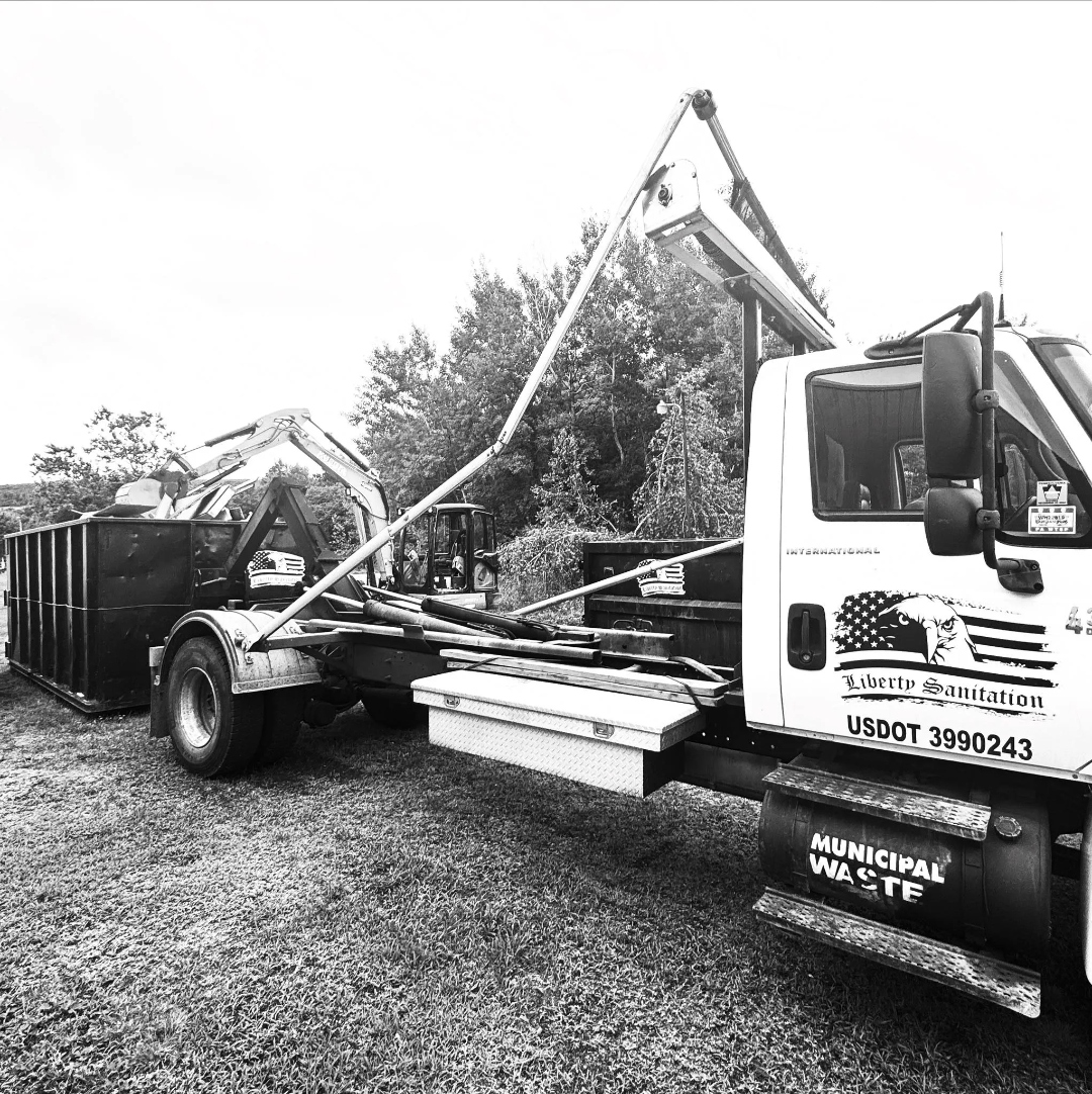 Liberty Sanitation roll-off truck with dumpster containers and equipment